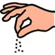 Hand streut Gewürz über Speise